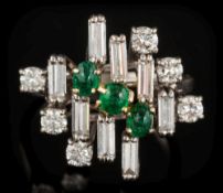 An emerald and diamond informal cluster ring: with three oval cabochon emeralds,