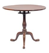 A mid 18th Century mahogany circular tea table:, with a snap top on turned baluster column,