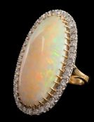 A large opal and diamond oval cluster ring: the central,