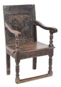 A 17th Century carved stained elm open armchair:, the panelled back with arcaded,