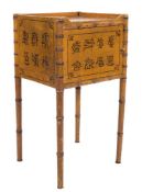 A 19th Century ochre painted and simulated bamboo pot cupboard:, with a tray top,