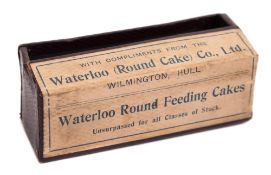 A 'Laughing Camera' :, in red with gilt text, paper label, 'Compliments of Waterloo (Round Cake) Co,