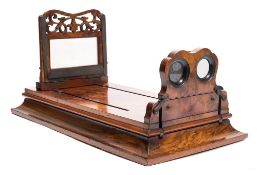 A Victorian walnut graphoscope:, the 6 1/4 inch magnifying lens over stereo cards viewers,