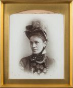 A late 19th century portrait photograph on opaque glass:, of a woman looking to dexter,