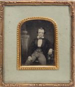 A mid 19th century hand tinted ambrotype portrait of a boy :,