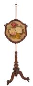 A Victorian carved mahogany polescreen:, with turned finial and column,