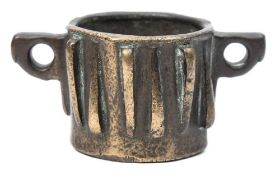 A Spanish octagonal bronze mortar: of small size with loop handles and twelve alternating