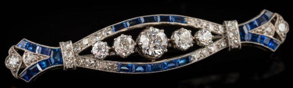 A synthetic sapphire and diamond elliptical bar brooch: set with graduated old,