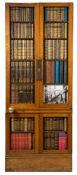 An oak library door with book spine fronts:, on a plinth base,