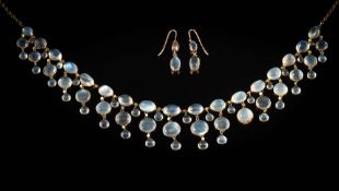 A moonstone fringe necklace: with round and oval moonstones in spectacle frame settings,