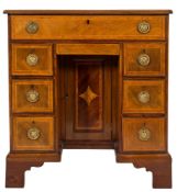 An early 19th Century mahogany and later inlaid kneehole desk:,