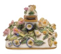 A Rockingham flower encrusted perfume bottle and stopper: of compressed square section applied with