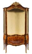A French kingwood, satinwood veneered and gilt metal mounted serpentine-fronted bombe vitrine:,