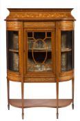 An Edwardian mahogany and inlaid display cabinet:, of D-shaped breakfront outline,