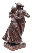 A French carved wood group of a dancing couple: in traditional costume, mounted on a square base,