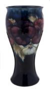 A Moorcroft pottery vase: of waisted form, tube lined in the Pansies pattern in white, blue, red,