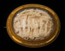 A late 19th century Cantonese carved ivory and gold oval glazed brooch: depicting figures on a