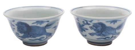 A pair of small Chinese blue and white wine cups: with flared rims,