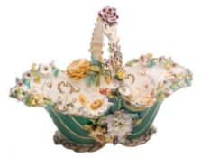 A large Coalport flower encrusted basket: with green ground exterior,