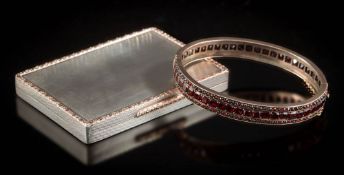 A Bohemian garnet mounted hinged bangle and a silver cigarette case with chased gold border and