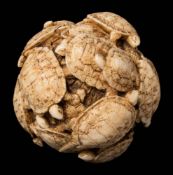 A Japanese carved ivory okimono: in the form of a ball of sea turtles, unsigned, 5cm. diameter.