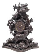 A Black Forest carved walnut mantel clock: the eight-day French movement striking the hours and