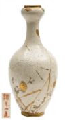 A Japanese Satsuma bottle vase: decorated with a crane flying above reeds and flowers on a ground
