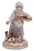 A Meissen porcelain figure: modelled after the original by Kaendler as a young girl feeding