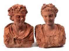 Two terracotta busts of a young woman and man: the man wearing a lion skin cloak,