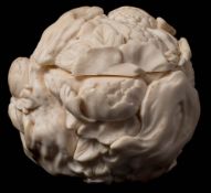 A Japanese carved ivory lidded jar: of spherical form carved with peonies and rockwork,