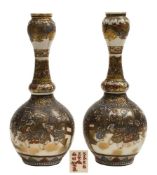 A pair of Japanese Satsuma gourd shaped bottle vases: each painted and gilded with panels of