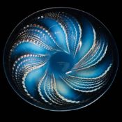 A Lalique shallow dish 'Fluerons': the mildly opalescent body embossed on the exterior with