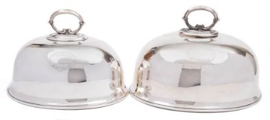 Two early 20th century silver plated graduated dish covers: of domed outline with loop carrying