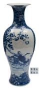 A Chinese porcelain vase: of slender baluster form with flaring neck painted in blue with a panel