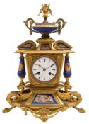 A gilt-metal and porcelain mantel clock: the eight-day duration movement striking the hours and