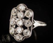 A platinum and diamond rectangular plaque cluster ring: with eleven round old,