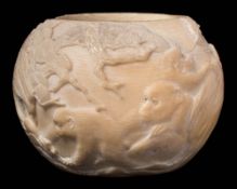 A Japanese carved ivory bowl: of circular outline, decorated with howler monkeys amongst pine trees,