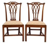 A pair of George III mahogany dining chairs in the Chippendale taste:,