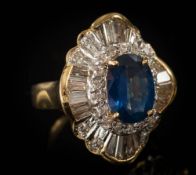 A sapphire and diamond ballerina cluster ring: centring an oval sapphire approximately 11mm long x