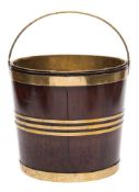 An 18th century mahogany and brass bound bucket: with brass loop carrying handle and brass liner,