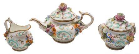 A mid 19th century English miniature flower encrusted part tea service: applied with floral sprays