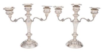 A pair of Elizabeth II silver twin-branch candelabra, maker W I Broadway & Co.