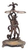 A bronze umbrella stand: the backplate cast as a male peasant in 18th century attire,