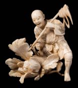 A Japanese carved ivory okimono of a peasant: the figure holding a plough and surprised by a snake