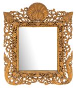A 19th Century Indian carved gilt wood easel mirror:, with scallop shell cresting,