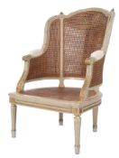 A French carved wood and grey and gilt decorated Bergere armchair:,