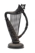 A late 19th century Irish carved bog oak harp: of Celtic design,