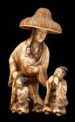 A Japanese carved ivory okimono: of Lady Tokiwa Gozen with her three small children fleeing in the