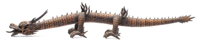 A Japanese carved boxwood articulated dragon: with open mouth, sliding tongue, hinged body and legs,