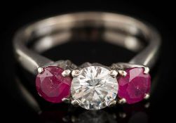 A ruby and diamond three-stone ring: with central round, brilliant-cut diamond approximately 5.